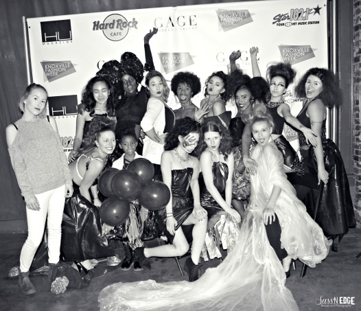 Models and designers from trash bag collection show posing for a group picture at the trash collection show.
